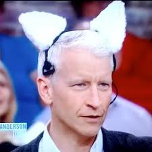 Anderson Cooper wearing a pair of robotic cat ears